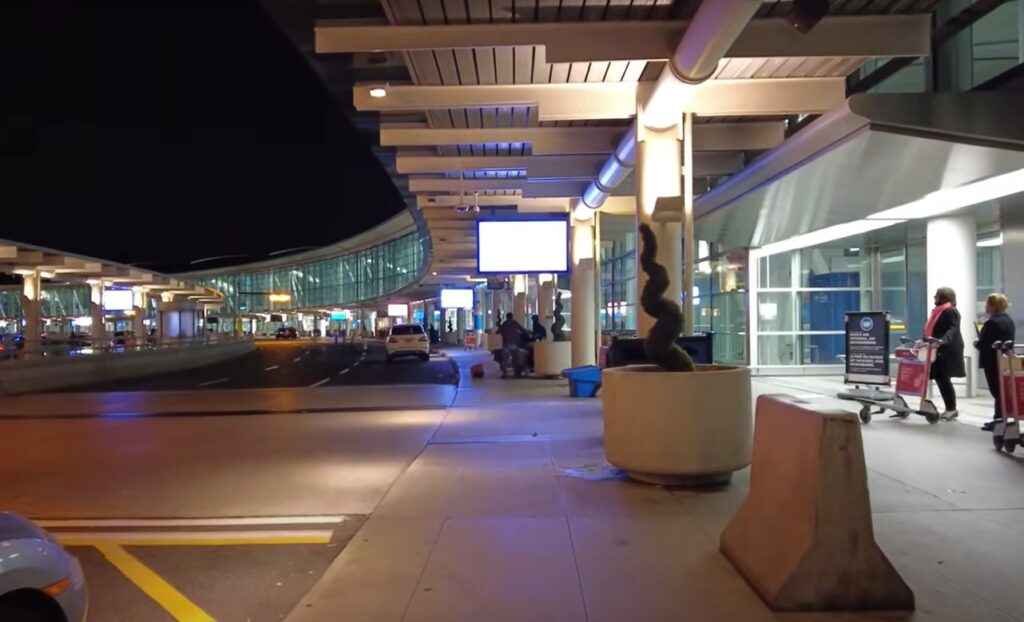 "Toronto Pearson Airport main terminal view with parked airplanes and passengers."